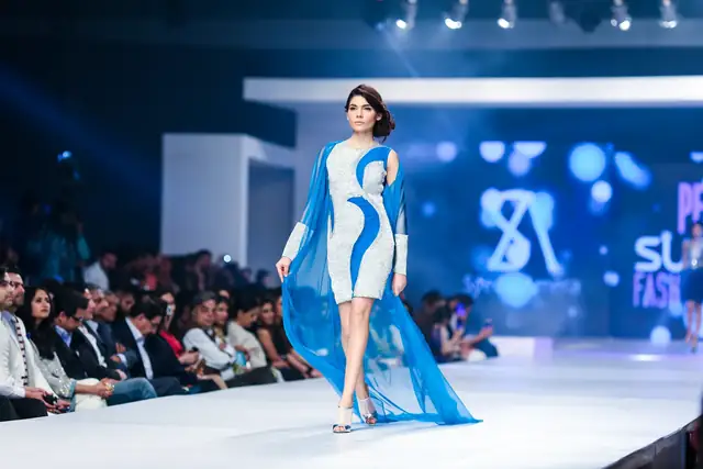 Runway fashion photography of a model in a pink gown